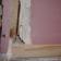 Figure 2: Detachment of plasterboard from timber frame at lower corner of wall at maximum cyclic displacement.